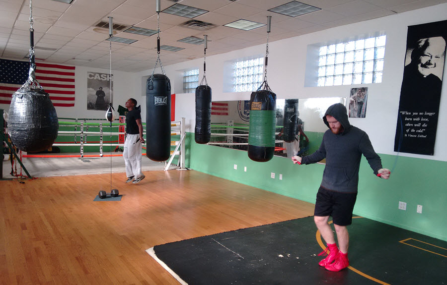 Coach Dan Letz and trainee Gregory George warm up before a sparring session.