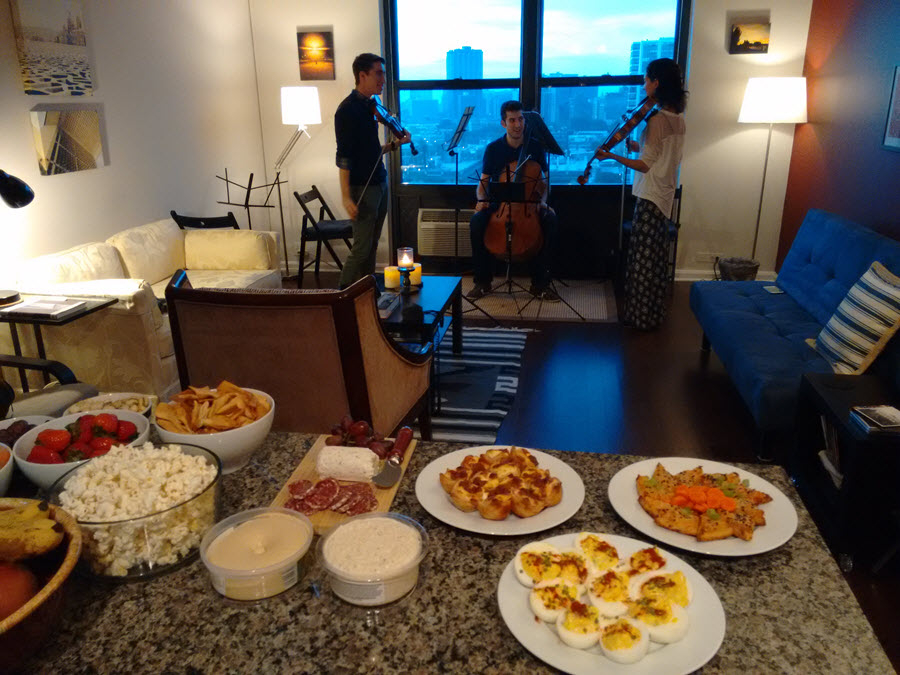 Violinist Davis Butner (left) laid out a beautiful spread as host of a recent GroupMuse event in his Lakeview apartment.